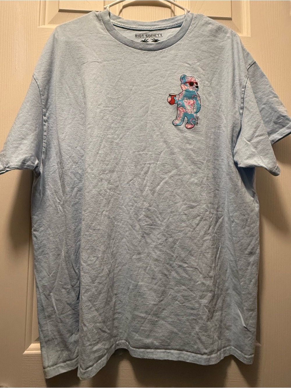 riot society light blue short sleeve tee with colorful bear graphic